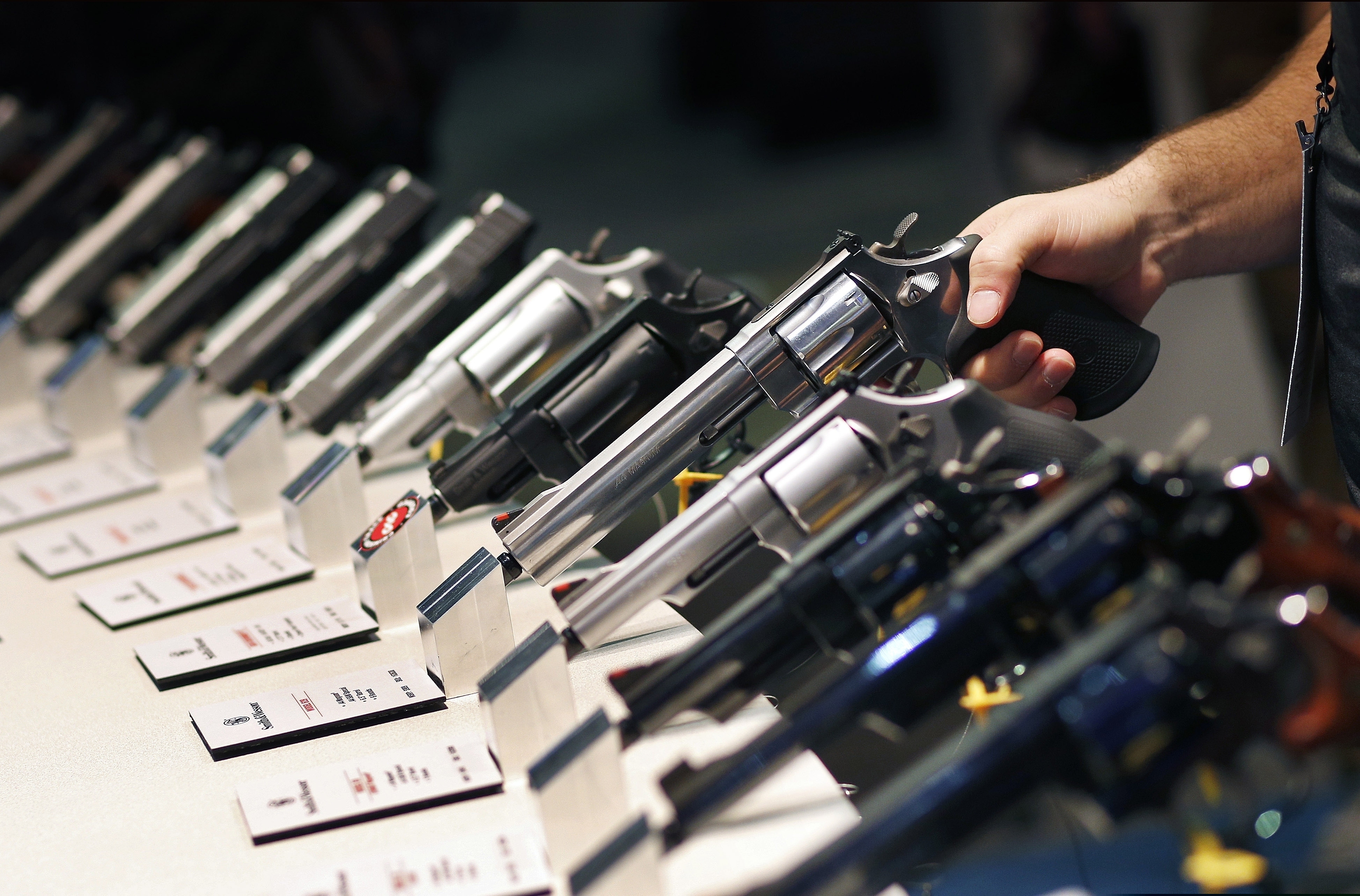 (John Locher | AP file photo) In this Jan. 19, 2016, file photo, handguns are displayed at the Smith & Wesson booth at the Shooting, Hunting and Outdoor Trade Show in Las Vegas. The U.S. House has passed legislation that would close the so-called gun show loophole, requiring background checks for all gun sales, including private transactions.