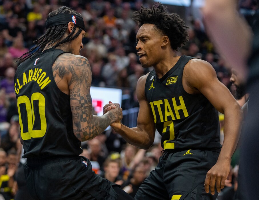 (Rick Egan | The Salt Lake Tribune) Utah Jazz guard Jordan Clarkson (00) is helped up off the floor by Utah Jazz guard Collin Sexton (2) in NBA action between the Utah Jazz and the Brooklyn Nets at Vivint Arena, on Friday, Jan. 20, 2023.