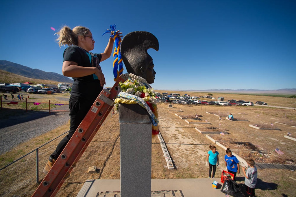 (Trent Nelson | Salt Lake Tribune file photo) Lina Ahquin puts a lei on a historical monument, as Hawaiian descendants gather to clean the graves of their ancestors on Saturday, May 26, 2018, as part of the annual celebration in Iosepa, a ghost town that was a settlement for Native Hawaiians who immigrated to Utah in the early 20th century. This year's celebration, previously set for May 28-29, 2022, has been postponed due to concerns about COVID-19.