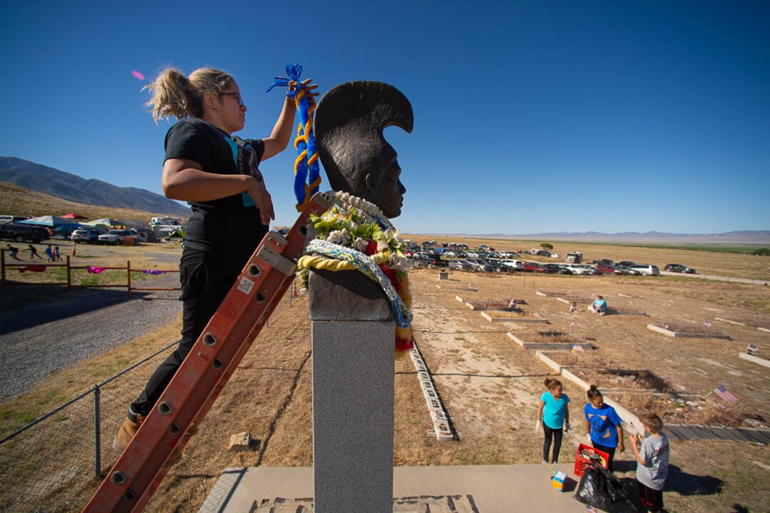 (Trent Nelson | The Salt Lake Tribune)  Descendants of the Hawaiians who settled the desert town of Iosepa took time during their Memorial Day gathering to clean the graves of their ancestors, Saturday May 26, 2018.  Lina Ahquin puts a lei onto a historical monument.