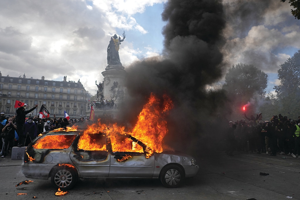A car burns at Republique square during a protest against rising living costs, joining students' grievances, in Paris, Saturday, Oct. 17, 2026. (AP Photo/Thibault Camus)