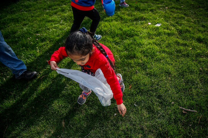 (Nicole Boliaux | For The Tribune) Children and their families run to grab Easter eggs during the annual Easter egg hunt put on by A Kid's Place Dentistry in Liberty Park in Salt Lake City on Saturday, March 31, 2018.