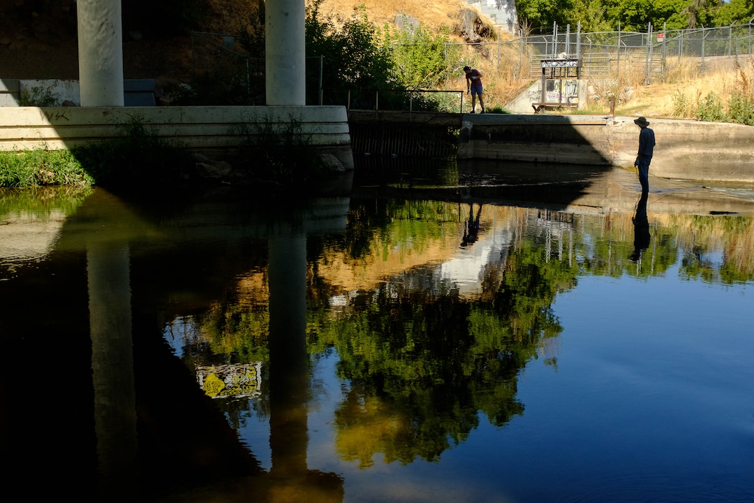 (Trent Nelson  |  The Salt Lake Tribune)  
A pair of volunteers magnet fishing the Weber River on Saturday Aug. 31, 2019. Volunteers assisted the Utah Cold Case Coalition, hoping to find evidence in several cases.