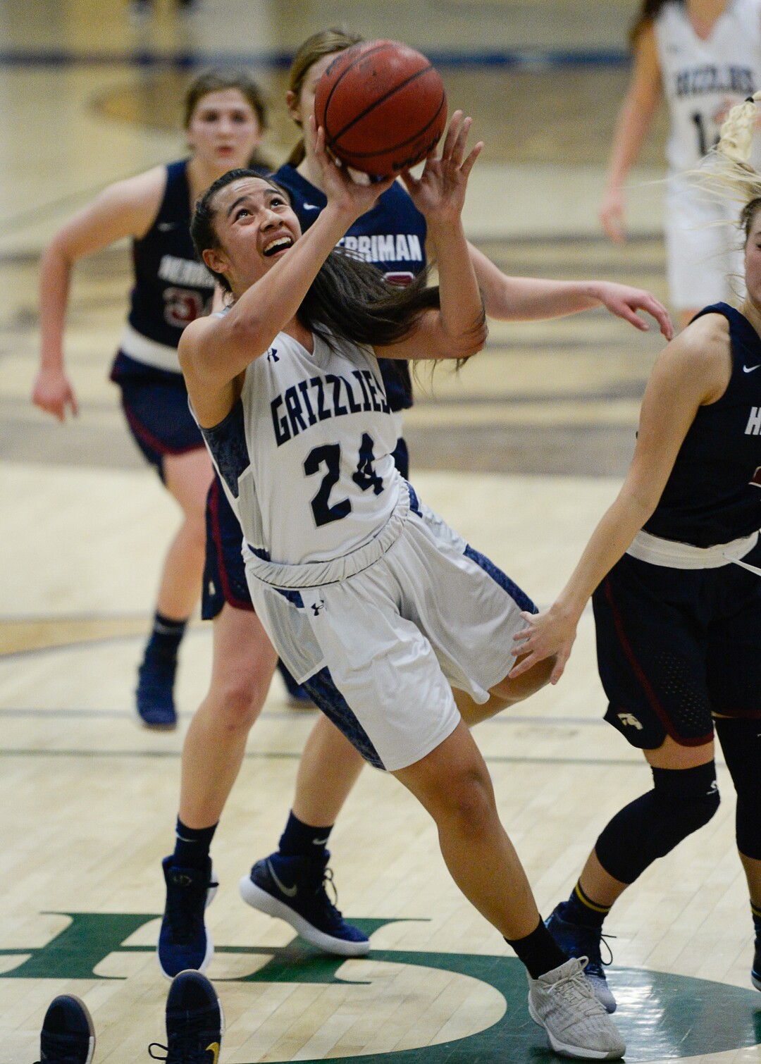 (Francisco Kjolseth  |  The Salt Lake Tribune)  Laci Olsen of Copper Hills loses her balance on the way to the basket against Herriman in West Jordan on Thursday, Jan. 25, 2018.
