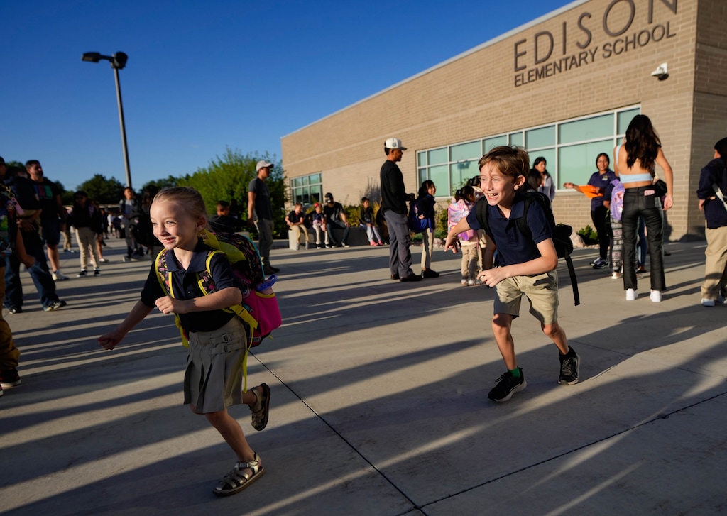 (Francisco Kjolseth  | The Salt Lake Tribune) Aislin Butters, 6, is chased by her brother, John, 9, for the start of their first day of school at Edison Elementary on Tuesday, Aug. 20, 2024. More than a dozen Salt Lake City elementary schools welcomed new students from now-closed campuses.
