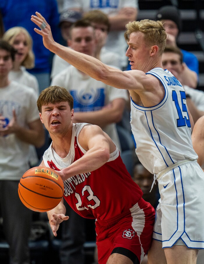 (Rick Egan | The Salt Lake Tribune)  South Dakota Coyotes guard Paul Bruns (23) is guarded by Brigham Young Cougars guard Richie Saunders (15), in basketball action between the Brigham Young Cougars and the South Dakota Coyotes, at Vivint Arena, in Salt Lake City, on Saturday, Dec. 3, 2022.
