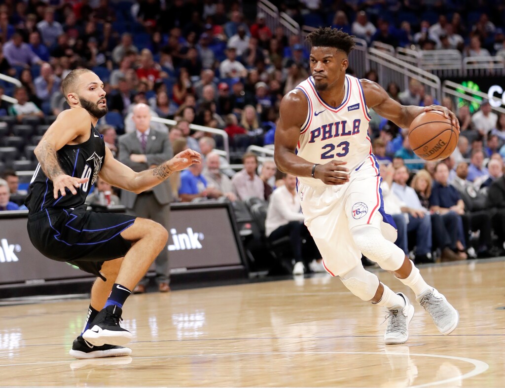 Philadelphia 76ers' Jimmy Butler (23) drives past Orlando Magic's Evan Fournier during the first half of an NBA basketball game Wednesday, Nov. 14, 2018, in Orlando, Fla. (AP Photo/John Raoux)