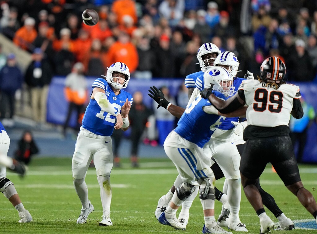 (Francisco Kjolseth  | The Salt Lake Tribune) Brigham Young Cougars quarterback Jake Retzlaff (12) makes the game winning pass in the final seconds of the game for a 38-35 win over the Oklahoma State Cowboys in Provo on Friday, Oct. 18, 2024.