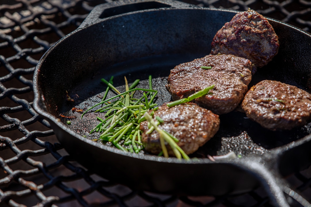 Thosh Collins prepares venison burgers with i’itoi onions on the Salt River Pima-Maricopa Indian Community, a few miles from their home outside Scottsdale, Ariz., on April 5, 2020. Collins and his wife, Chelsey Luger, founded an Indigenous wellness program called Well for Culture. (Caitlin O'Hara/The New York Times)