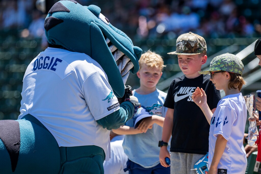 (Rick Egan | The Salt Lake Tribune) Kids line up to get an autograph from Oggie the Raptors mascot during a game between the Ogden Raptors and the Northern Colorado Owlz at Lindquist Field on Sunday, June 29, 2025.