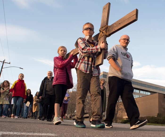 (Rick Egan  |  The Salt Lake Tribune)     Cal Burke, 11, and Grace Carlson, 12, from Layton, carry the cross as members of Christian denominations participate in the annual Good Friday procession through downtown Salt Lake City, Friday, March 30, 2018. The procession commemorating Christ's path to crucifixion has been a tradition of the Salt Lake Council of Churches since 1988. 


