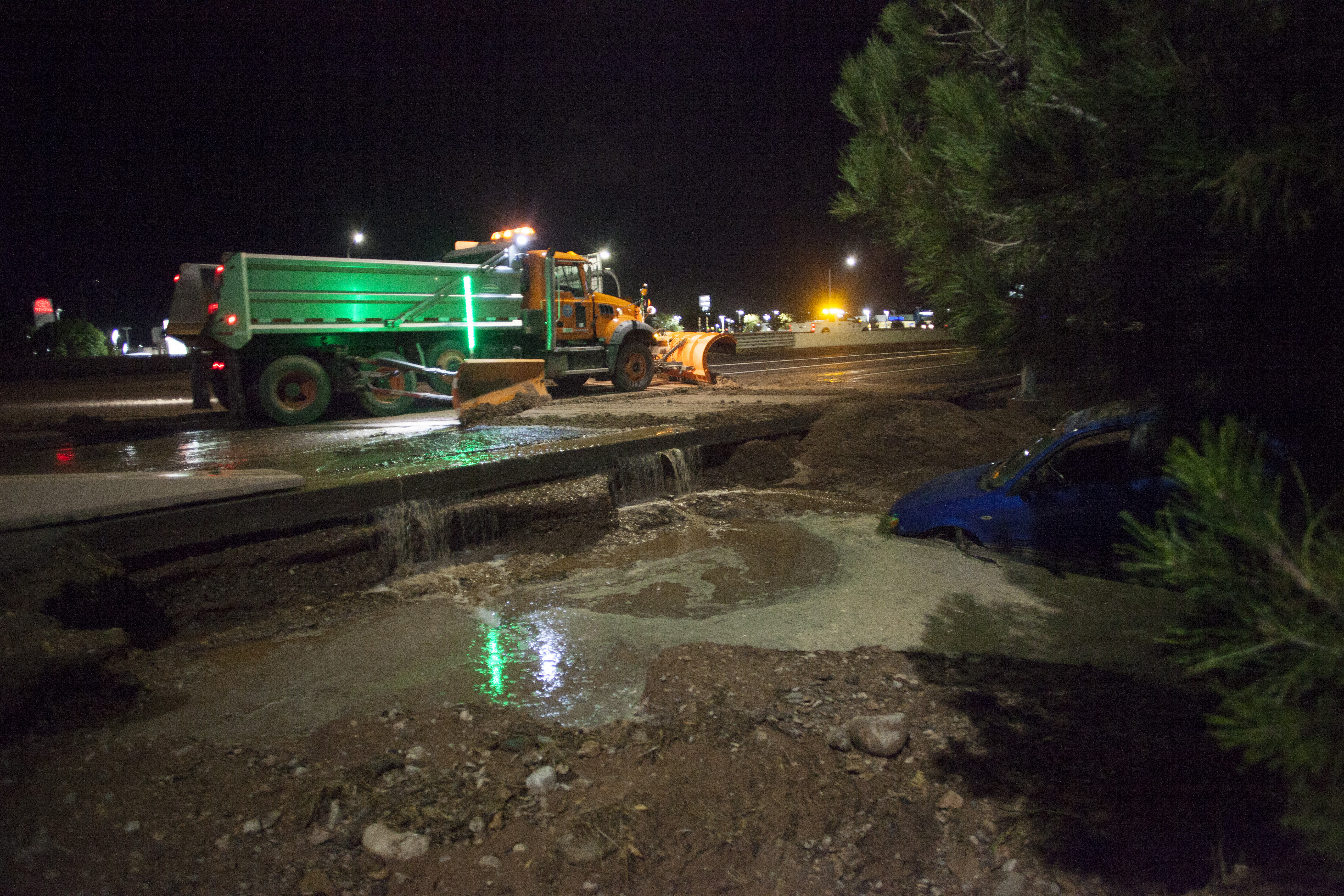 (Chris Caldwell | The Spectrum via AP) A car comes to rest between I-15 and the Dixie Convention Center after flood water moved barricades and washed away the shoulder Monday, Aug. 24, 2020.