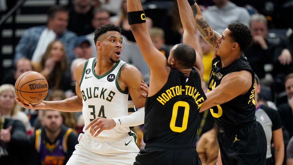 Utah Jazz's Talen Horton-Tucker (0) and Juan Toscano-Anderson, right, defend against Milwaukee Bucks forward Giannis Antetokounmpo (34) during the first half of an NBA basketball game Friday, March 24, 2023, in Salt Lake City. (AP Photo/Rick Bowmer)