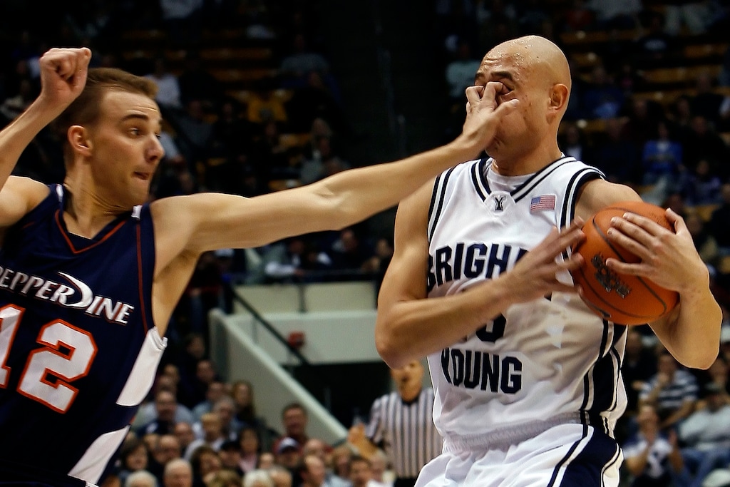 (Chris Detrick  |  The Salt Lake Tribune) Pepperdine's Jason Walberg (12) gouges the eyes of BYU's Jonathan Tavernari (45) during the game at the Marriott Center on Dec. 15, 2007.  No foul was called on the play.