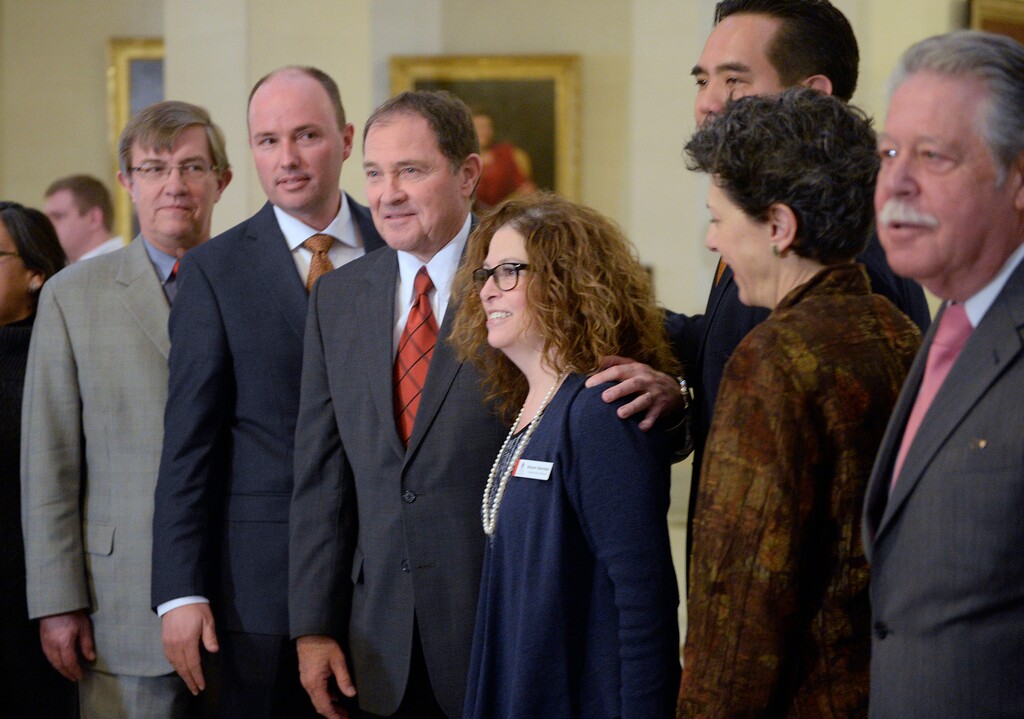 (Al Hartmann | Tribune file photo) Gov. Gary Herbert, center, with Allyson Gamble, Executive Director of the Capitol Presrvation Board pose with other state officials Monday Jan 4 after the unveiling of a mosaic of the state symbol that commemorates Utah Statehood Day and the 100th anniversary of the construction of the Capitol building.