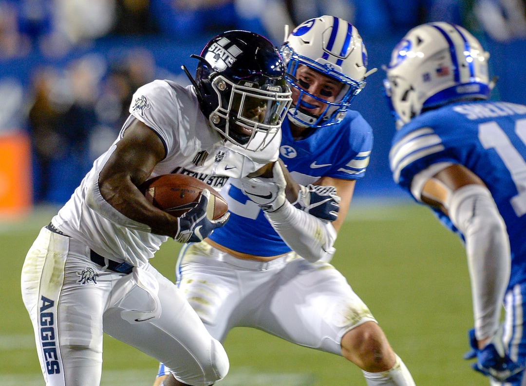 Leah Hogsten  |  The Salt Lake Tribune  Utah State Aggies running back Gerold Bright (8) is brought down by Brigham Young Cougars linebacker Zayne Anderson (23) as BYU hosts Utah State University at Lavell Edwards Stadium in Provo, Friday, Oct. 5, 2018.