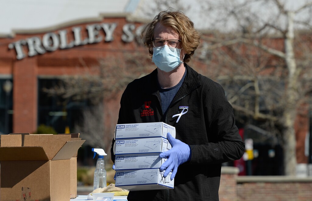 (Francisco Kjolseth  |  The Salt Lake Tribune) Drew Crawford, a University of Utah third-year medical student, helps at a drop-off for donations of medical supplies — masks, gloves, gowns, etc., at the auxiliary parking lot just south of Trolley Square in Salt Lake City on Friday, April 3, 2020. The donation drive continues from 10 a.m. to 3 p.m. through Sunday at the lot before moving on to West High School next Friday through Sunday, and subsequent locations after that.