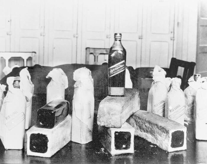 FILE - In this June 12, 1924, file photo bottles of Scotch whiskey smuggled in hollowed-out loaves of bread are pictured, location unknown. Statistically, Prohibition was not an utter failure. Deaths from alcohol-related cirrhosis declined, as did arrests for public drunkenness. What the statistics don't measure is how extensively Prohibition was flouted. Bootleggers established vast distribution networks. (AP Photo, File)