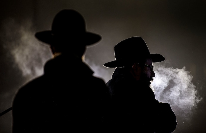 (Steve Griffin  |  The Salt Lake Tribune)   Rabbi Benny Zippel of Chabad Lubavitch, right, is joined by his son, Rabbi Avremi Zippel as they light a giant menorah for the first night of Hanukkah, the Jewish eight day festival of lights outside, Abravanel Hall in Salt Lake City Tuesday December 12, 2017.