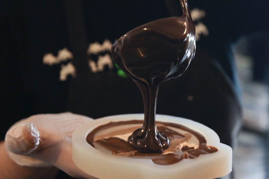 (Evan Cobb | The Daily Herald | The Associated Press) In this Thursday, Dec. 21, 2017 photo, Jennie Hales pours fresh chocolate into a nativity scene mold in the Truffle Cottage's kitchen, in Pleasant Grove, Utah.
