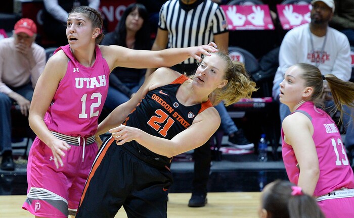 Scott Sommerdorf | The Salt Lake TribuneUtah Utes forward Emily Potter (12) follows through and smacks Oregon State Beavers center Marie Gulich (21) on the face as she follows the flight of a rebound during first half play. Utah led Oregon State 36-34 at the half, but lost the game 69-58, Friday, January 26, 2018.