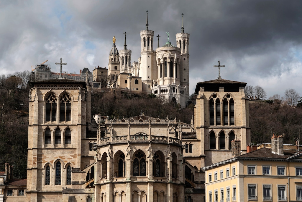 (AP Photo/Laurent Cipriani) The Saint-Jean Cathedral, foreground, and the Fourviere Basilica, top, are pictured in Lyon, central France, Thursday, March 7, 2019. France's top Catholic official Cardinal Philippe Barbarin said he will offer his resignation to Pope Francis, after a court found him guilty of failing to report allegations of sexual abuse of minors by a priest.