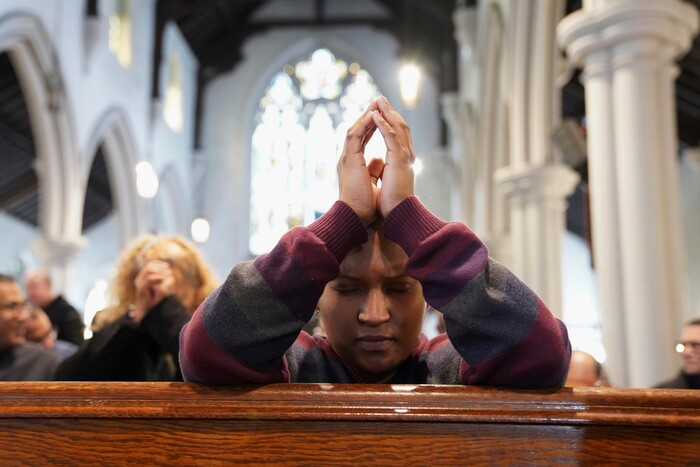 In this Sunday, Dec. 15, 2019, photo, Diely Martinez, 30, prays inside the Holyrood Episcopal Church-Iglesia Santa Cruz in New York. Martinez started volunteering as a sermon interpreter after her mother, who is deaf, began attending the church last year. (AP Photo/Emily Leshner)