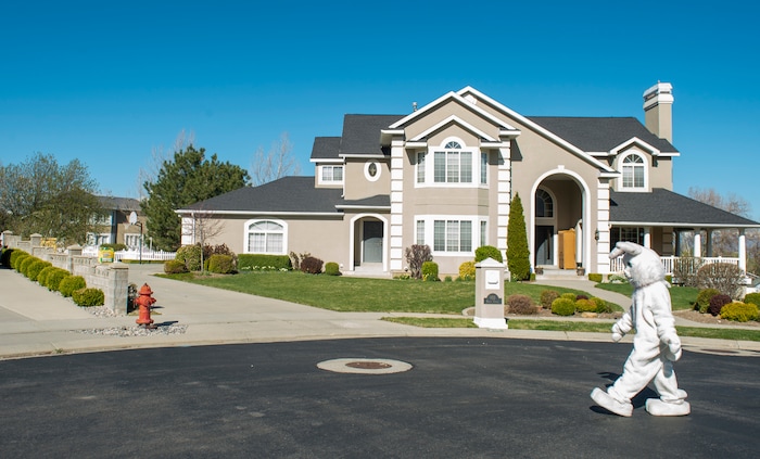 (Rick Egan  |  The Salt Lake Tribune)     Makea Kelly dresses as the Easter Bunny, as she she assists Draper City Parks and Recreation workers, the police and the fire department, as they deliver more than 30,000 Easter eggs to children at their doorsteps in Draper, Friday, April 10.