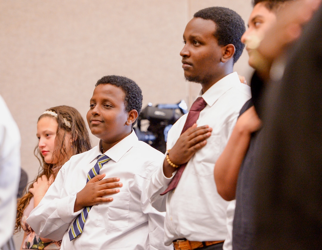 Leah Hogsten  |  The Salt Lake Tribune  l-r With hands on their hearts brothers Michael and Biruk Mekonnen and other youth, ages 5 to 22, representing 8 countries, spoke the oath of citizenship as America's newest citizens during a youth naturalization ceremony at the Viridian Event Center in West Jordan, Monday, August 6, 2018. 