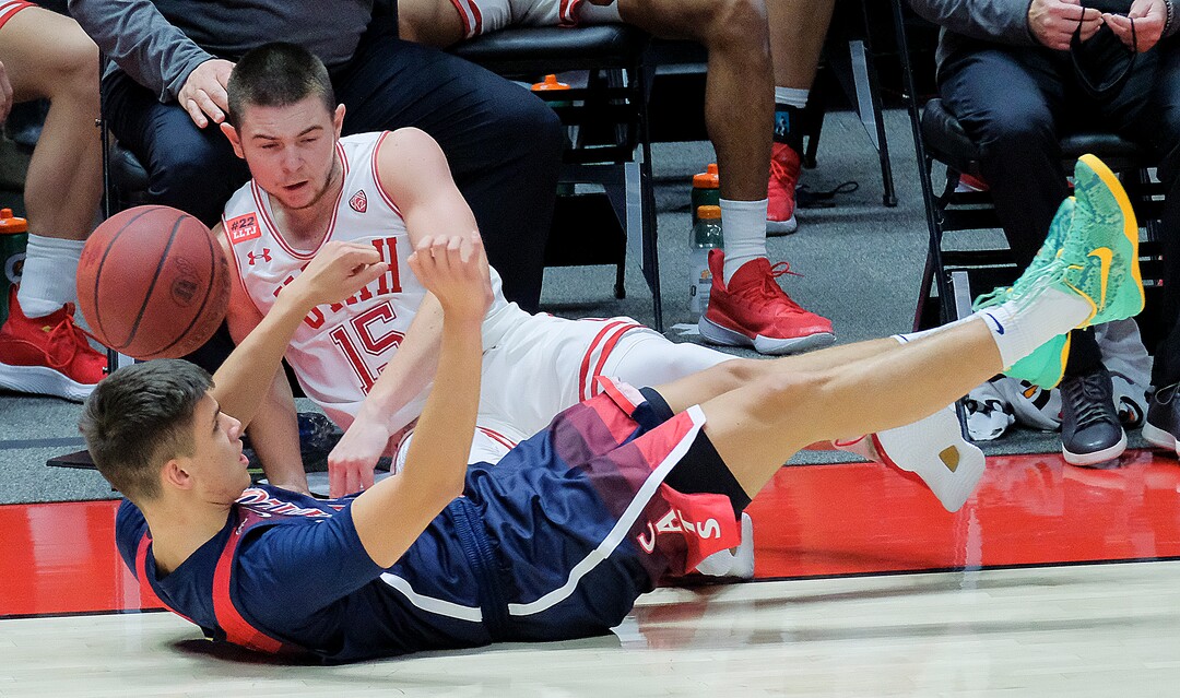 (Leah Hogsten | The Salt Lake Tribune) A foul is called on Utah Utes guard Rylan Jones (15) as he hits the deck with Arizona Wildcats guard Kerr Kriisa (25) as the University of Utah host the Arizona Wildcats, Feb. 4, 2021 at the Jon M. Huntsman Arena.