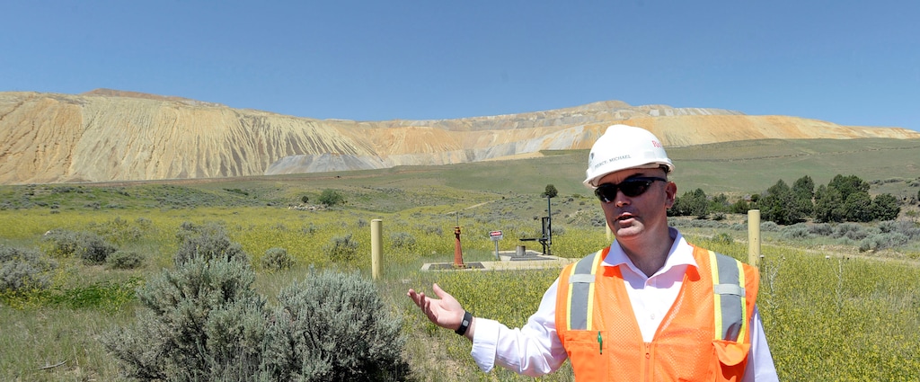 (Al Hartmann | Tribune File Photo) Rio Tinto's general manager of construction Michael Piercey stands in the foreground of a former rail dump that was rehabilitated in the 1990s on June 22, 2015. The native vegetation has taken hold at the bottom of the tailings mountain. Utah's exports of nonferrous metals, like copper, make it one of the biggest exporters of that commodity in the United States.