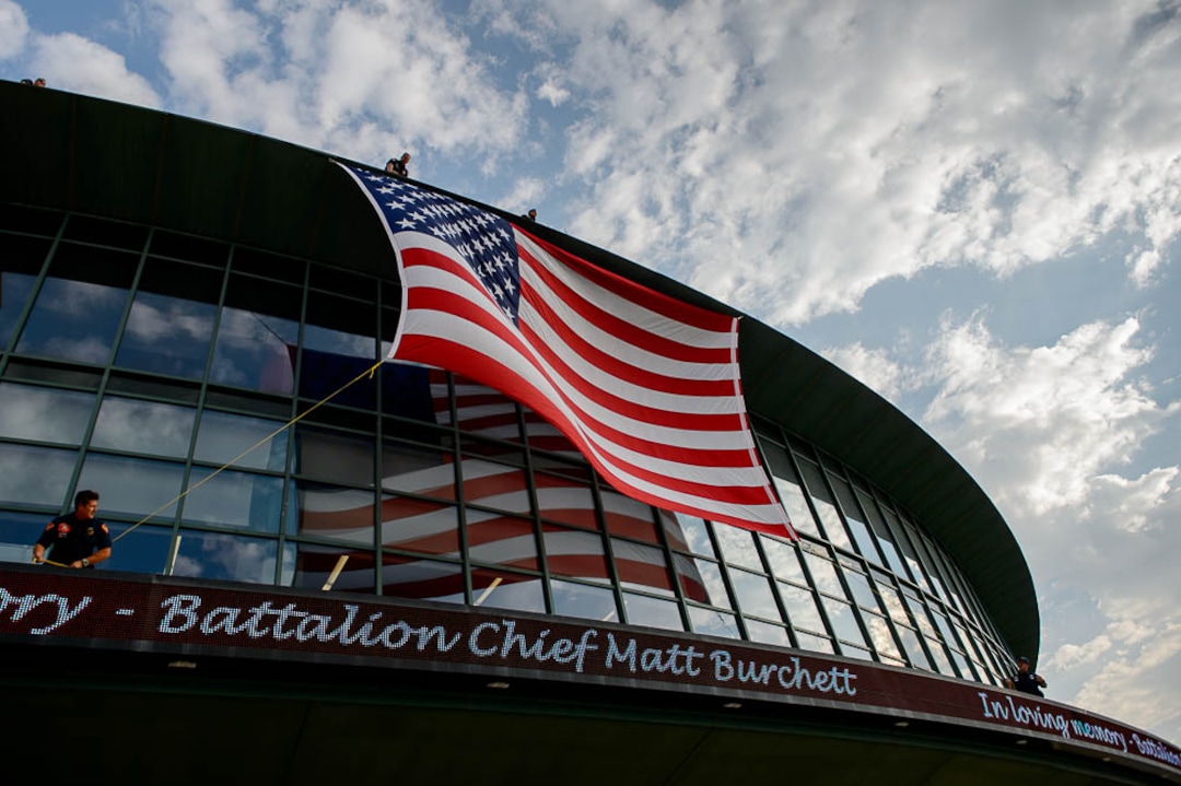 (Trent Nelson | The Salt Lake Tribune)  Firefighters secure a flag at the funeral services for Battalion Chief Matthew Burchett at the Maverik Center in West Valley City, Monday Aug. 20, 2018.