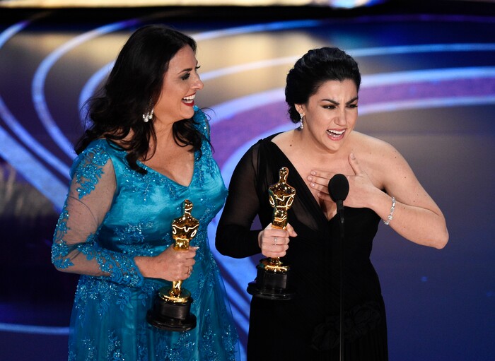 Melissa Berton, left, and Rayka Zehtabchi accept the award for best documentary short subject for "Period. End of Sentence." at the Oscars on Sunday, Feb. 24, 2019, at the Dolby Theatre in Los Angeles. (Photo by Chris Pizzello/Invision/AP)