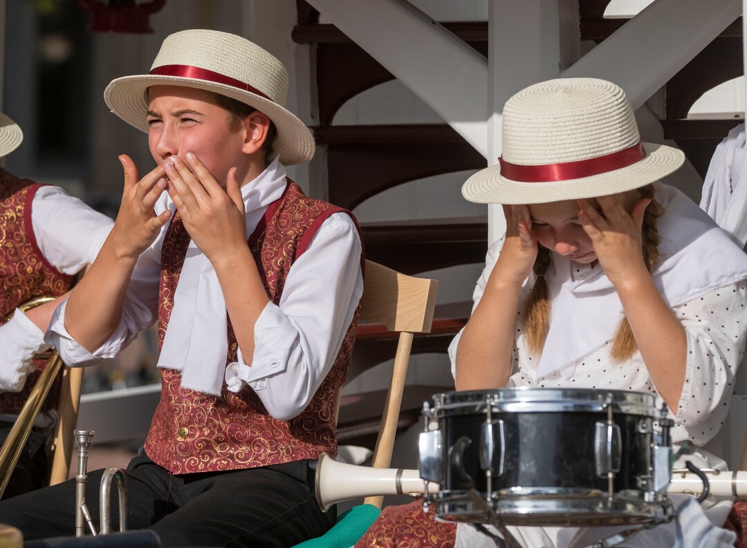 (Rick Egan | The Salt Lake Tribune) Members of the band on the Maid of Iowa float, for the Draper Utah Stake, put on sunscreen before the Days of '47 Parade, in Salt Lake City, on Friday, July 23, 2021.