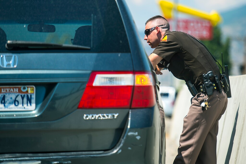 Chris Detrick | The Salt Lake Tribune
Utah Highway Patrol Trooper Derek Shelby talks to a driver who was pulled over for distracted driving on Interstate 15 Thursday, July 13, 2017.