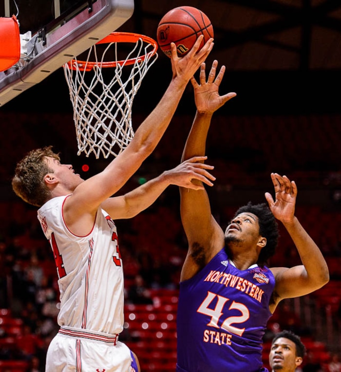 (Trent Nelson | The Salt Lake Tribune)  Utah Utes forward Jayce Johnson (34) defended by Northwestern State Demons center Larry Owens (42) as the University of Utah hosts Northwestern State, NCAA basketball in Salt Lake City, Wednesday December 20, 2017.