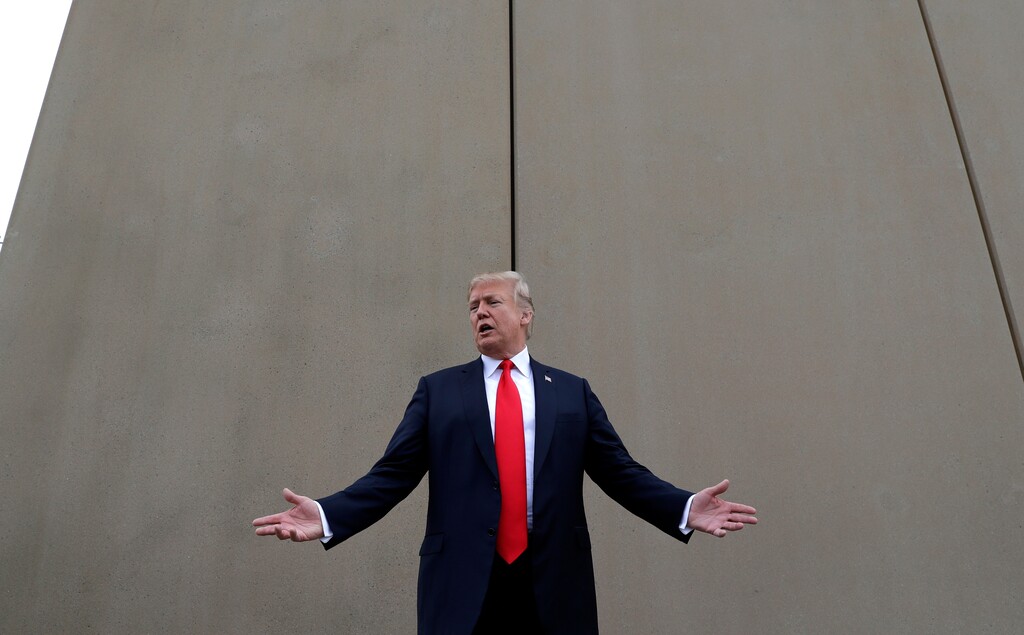 (Evan Vucci | The Associated Press) In this March 13, 2018 photo, President Donald Trump speaks during a tour as he reviews border wall prototypes in San Diego. Trump hails the start of his long-sought southern border wall, proudly tweeting photos of the “WALL!” Actually, no new work got underway. The photos show the continuation of an old project to replace two miles of existing barrier.