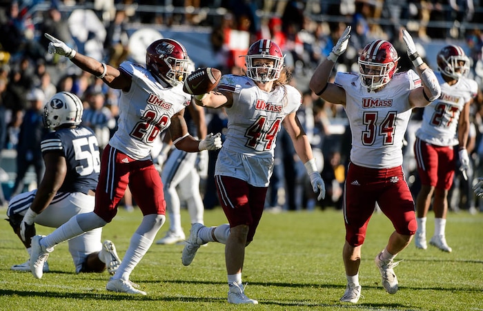 (Trent Nelson | The Salt Lake Tribune)  Massachusetts Minutemen linebacker Bryton Barr (44) celebrates an interception as BYU hosts the University of Massachusetts, NCAA football in Provo, Saturday November 18, 2017. At left is Massachusetts Minutemen linebacker Jarell Addo (26) and right is Massachusetts Minutemen linebacker Steve Casali (34).