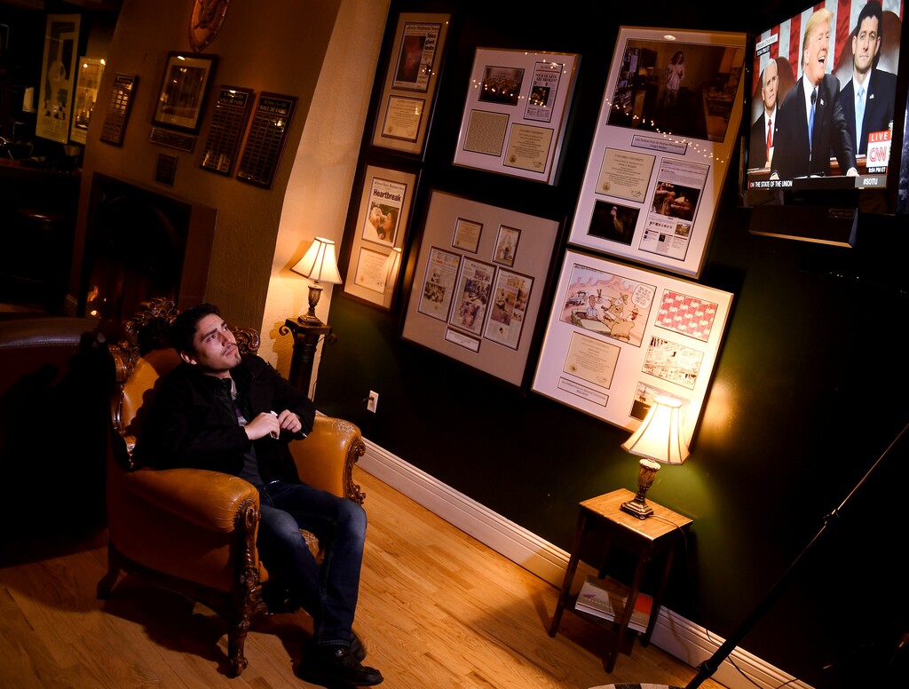 Mateo Lozano, 23, who was brought to the United States at the age of four, watches President Donald Trump as he lays out his immigration policy during a State of the Union watch party Tuesday, Jan. 30, 2018, in Denver. Lozano is concerned for the future of immigrant families.  (AP Photo/Thomas Peipert)