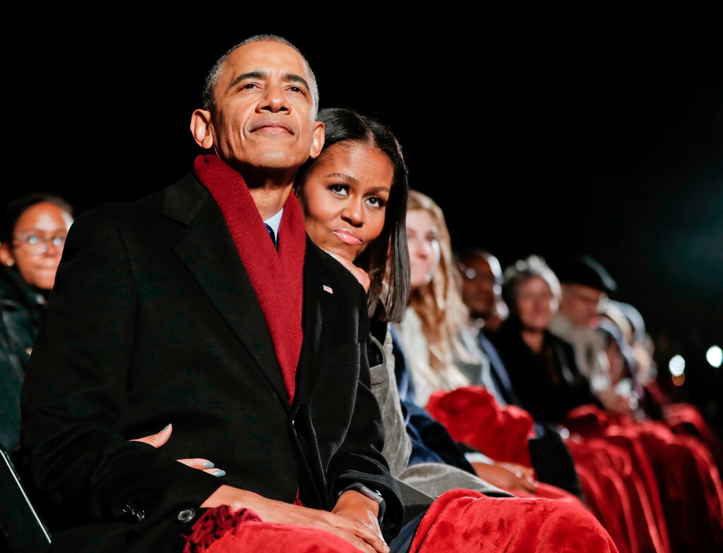 (AP Photo/Pablo Martinez Monsivais, File) In this Dec. 1, 2016 file photo, President Barack Obama and first lady Michelle Obama watch the 2016 National Christmas Tree lighting ceremony in Washington. The two Harvard Law School grads met at the Chicago corporate law firm Sidley & Austin when Michelle was 25 and assigned as mentor to the 27-year-old Barack, a summer associate.