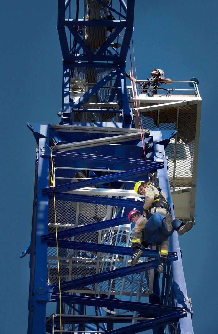 (Scott Sommerdorf | The Salt Lake Tribune) The Park City Fire District special operations team practices a tower crane operator rescue — a real possibility in the construction-rich environment of Summit County — utilizing a Jacobsen tower crane and operator at the construction site of the One Empire Pass development at Deer Valley, Sunday, Aug. 20, 2017.