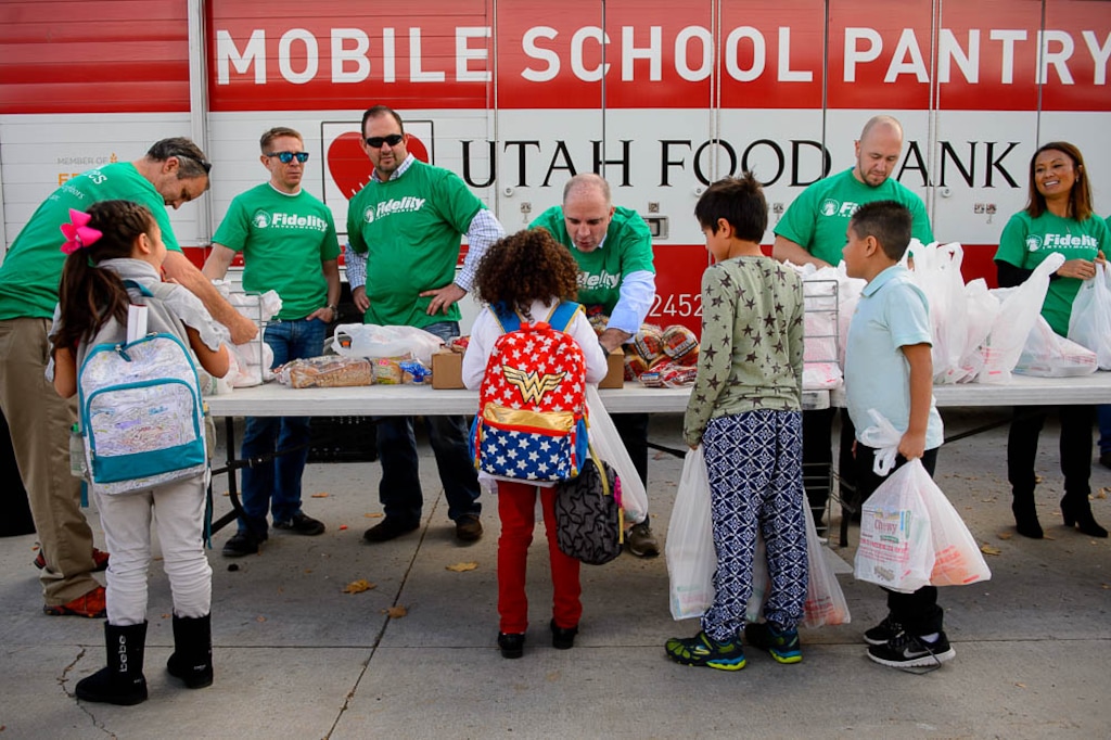 (Trent Nelson | Tribune file photo) Students at Jackson Elementary School in Salt Lake City pick up bags of food from volunteers from Fidelity Investments as part of the Utah Food Bank's mobile pantry on Nov. 2, 2017.
