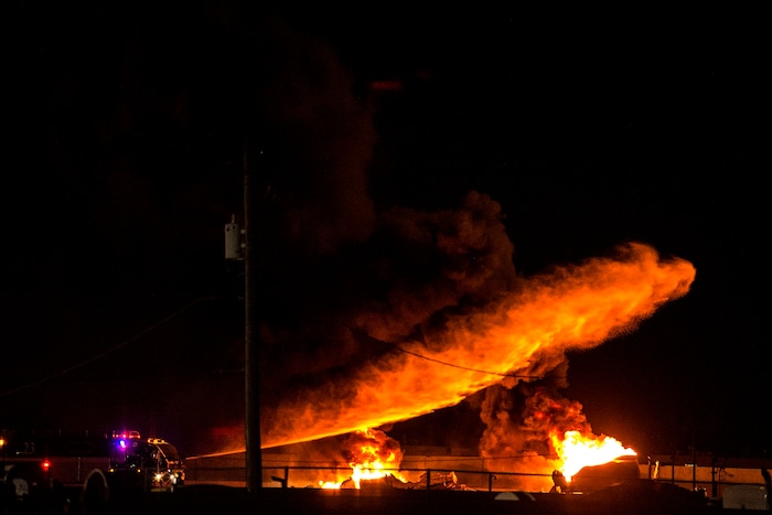 (Chris Detrick  |  The Salt Lake Tribune)  Firefighters attempt to put out a burning semitrailer that was hauling thousands of gallons of fuel on Interstate-15 in Midvale Thursday, January 18, 2018.   Lt. Todd Royce of the Utah Highway Patrol said the truck was southbound on the interstate at 7500 South at 7:20 p.m. when a tire caught fire, sending flames toward the tanks.