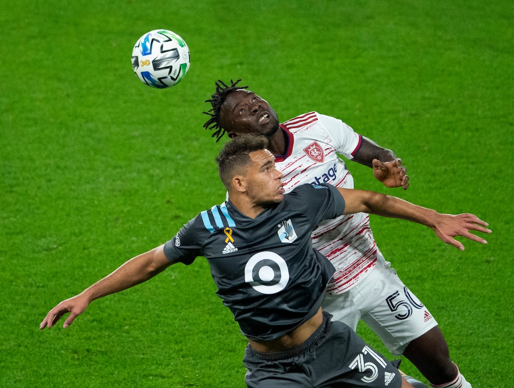Minnesota United midfielder Hassani Dotson (31) and Real Salt Lake forward Sam Johnson (50) compete for the ball during the second half of an MLS soccer match, Sunday, Sept. 27, 2020, in St. Paul, Minn. (Jeff Wheeler/Star Tribune via AP)