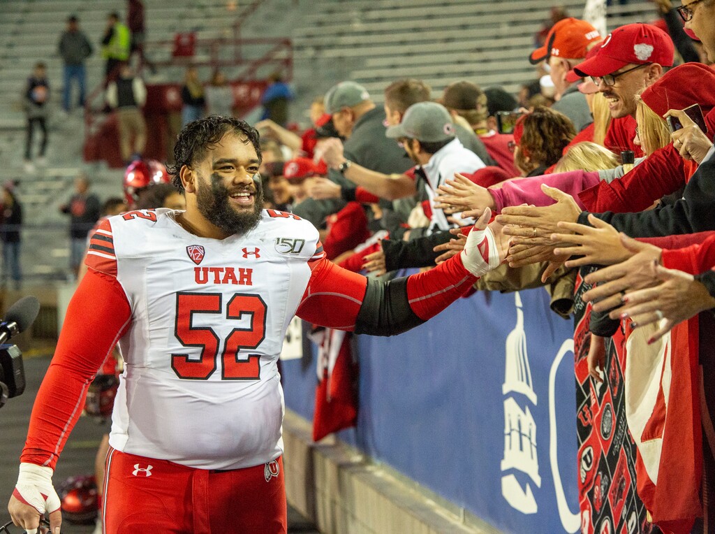 (Rick Egan  |  The Salt Lake Tribune)      Utah Utes defensive tackle John Penisini (52) greets the fans after the Utes defeated the Wildcats, 35-7, in PAC-12 action between the Utah Utes and the Arizona Wildcats in Tucson, Saturday, Nov. 23, 2019.