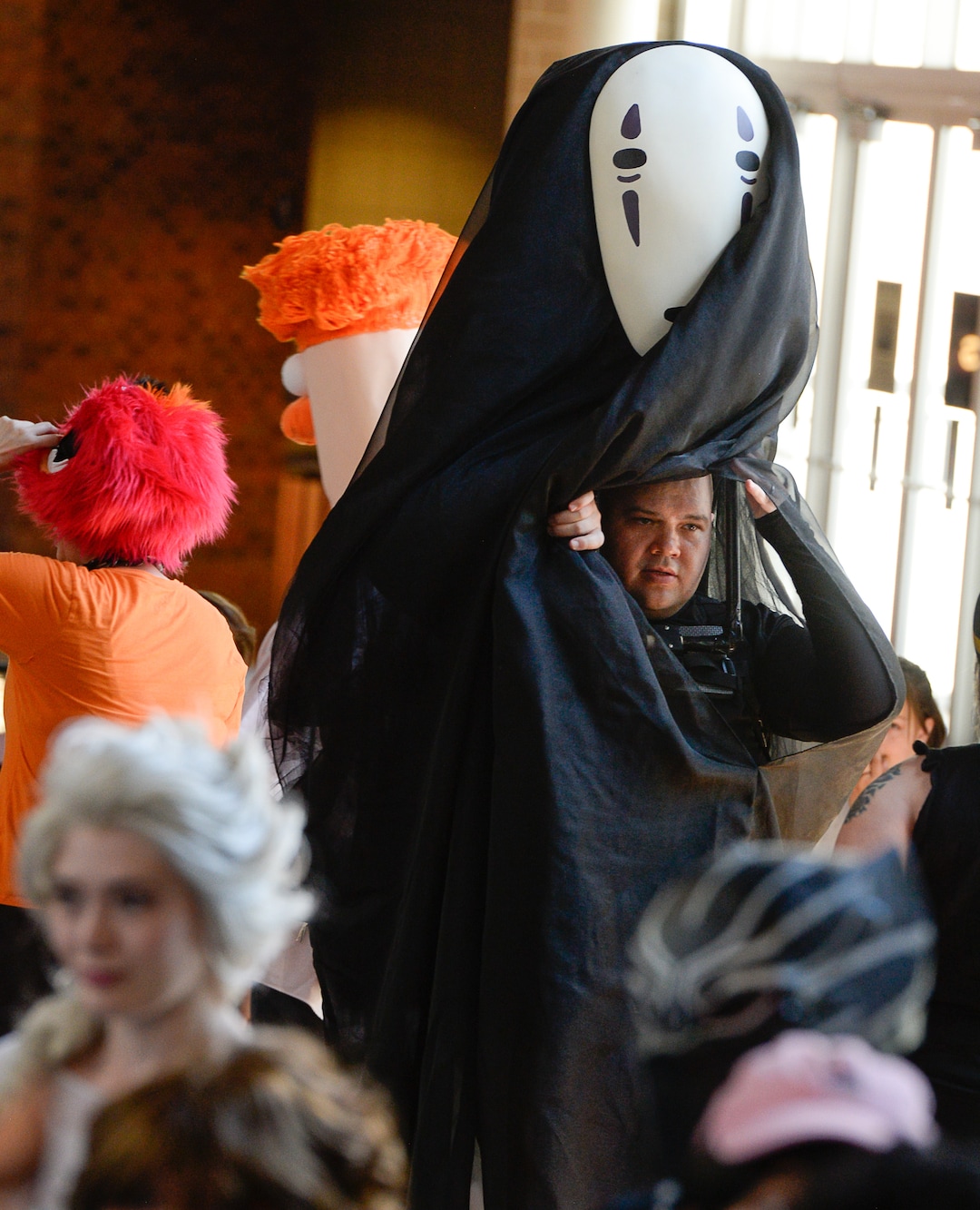 (Francisco Kjolseth  |  The Salt Lake Tribune)  Preston Goff peeks out from within his no face fictional character from the movie Spirited Away during FanX's twice-annual "press conference," drawing cosplayers to Megaplex Jordan Commons in Sandy on Wed. June 12, 2019, for the announcement of the event's celebrity visitors.