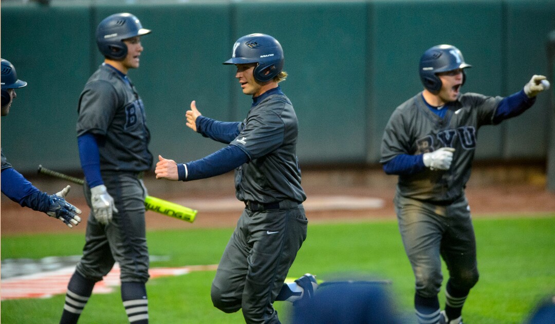 (Steve Griffin  |  The Salt Lake Tribune)  BYU players celebrate a two-run single by teammate Brian Hsu during the BYU versus Utah baseball game at Smiths Ballpark in Salt Lake City Tuesday April 3, 2018.