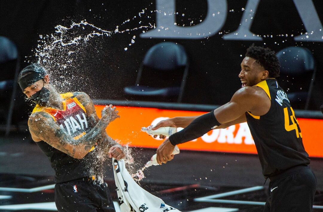 (Rick Egan | The Salt Lake Tribune)  Utah Jazz guard Donovan Mitchell (45) soaks Utah Jazz guard Jordan Clarkson (00) in the middle of his post game interview, after Clarkson's 40 point game, in NBA action between the Utah Jazz and the Philadelphia 76ers at Vivint Arena, on Monday, Feb. 15, 2021.