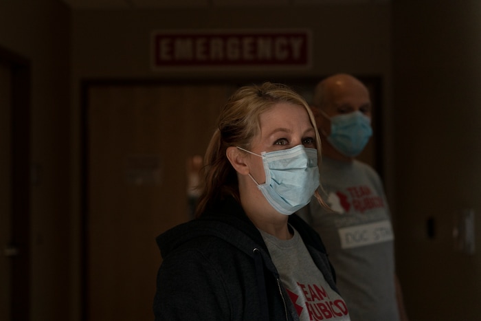 Team Rubicon volunteers, EMT Tracy Thomas from Omaha, Neb., and Dr. Stan Chartoff, with the U.S. Air Force Reserve from Hartford Conn., stand outside the emergency room at the Kayenta Health Center on the Navajo reservation in Kayenta, Ariz. on April 19, 2020. The reservation has some of the highest rates of coronavirus in the country. Team Rubicon is helping with medical operations as cases of COVID-19 surge. (AP Photo/Carolyn Kaster)