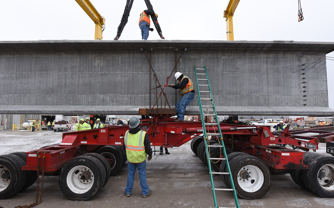 (Francisco Kjolseth  |  The Salt Lake Tribune)  UDOT gets ready to place some of the world's largest-ever bridge beams, and the largest in Utah state history with a span of 203 ft long and just over 8 ft tall, as crews load one on a truck following manufacturing at Forterra Structural Precast in Kearns on Tuesday, Dec. 11, 2018. A total of six beams will be installed in the technology corridor in Lehi later this week.